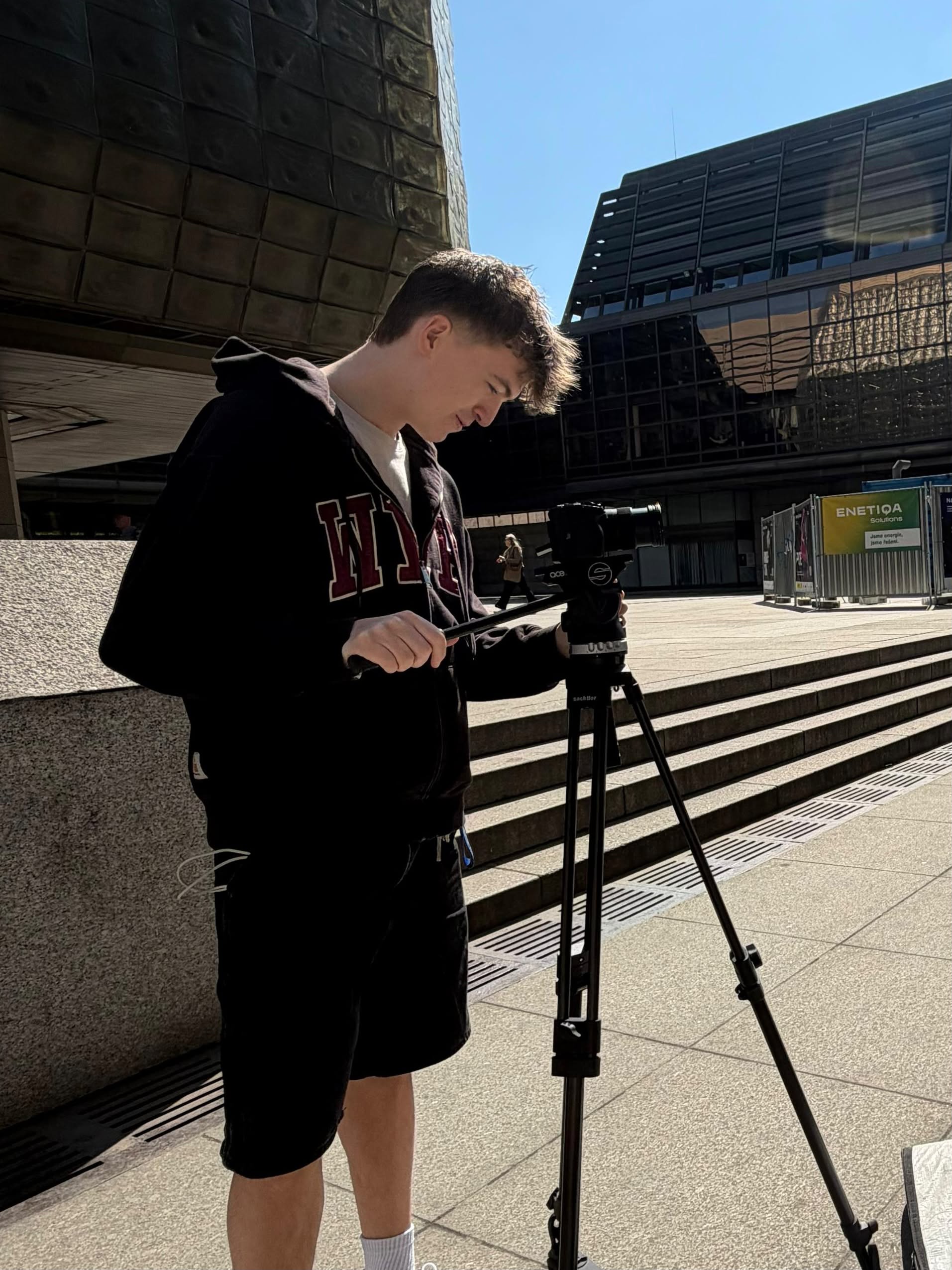 Julijan filming with a camera on a tripod